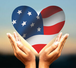 Hands holding a heart with American flag inside